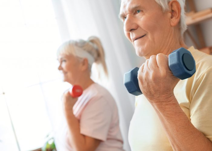 Senior,Couple,Exercise,Together,At,Home,Health,Care,With,Dumbbells